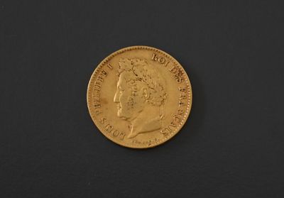 a gold coin on a black surface