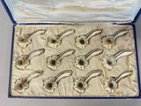 an open box with a bunch of pipe holders inside of it