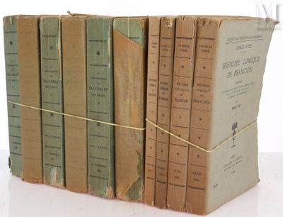 several old books stacked on top of each other on a table