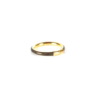 gros plan d'une bague en or sur fond blanc