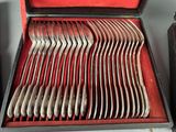 a lot of spoons in a case on the table