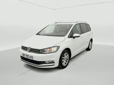 the white volkswagen touran is parked in a white room