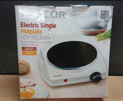 an electric single hotplate is in the box on the table