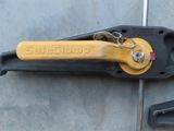 a close up of a yellow and black tool on the ground
