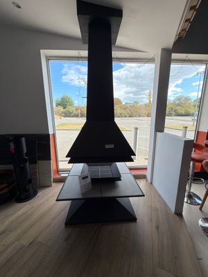 a fireplace in the middle of a living room with a view of the street