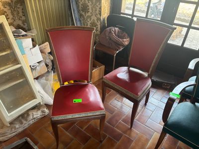 two red chairs sitting in a room with a window