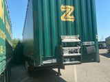two semi trucks parked next to each other in a parking lot