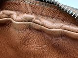 the inside of a brown purse with a zipper on it