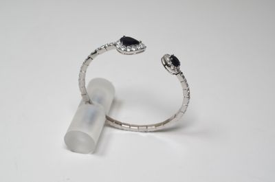 a close up of a ring on a white surface with a tube