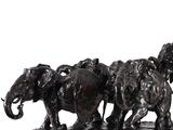 a statue of a group of elephants that are standing together