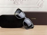 a pair of sunglasses sitting on a table next to a box