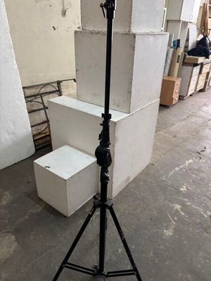 un appareil photo posé sur un trépied à côté d'une pile de cartons