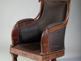 a brown chair with a black seat on a white background