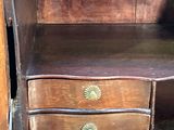 an old wooden cabinet with a drawer on it