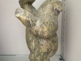a statue of a bear that is hanging on a wall