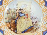 a plate with a picture of a woman and a cat on it