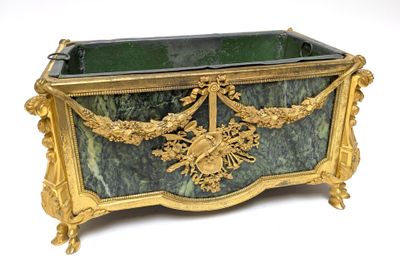 a green and gold box with a gold decoration on it