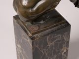 statue of a dog on a marble block with a white background
