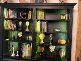 a black bookcase with many books on top of it