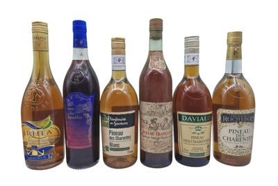 several bottles of alcohol are lined up on a white surface