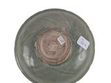 a green bowl with a brown lid on a white surface