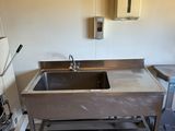 a kitchen with a sink and a stove in it