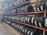 a bunch of tires are stacked on a rack in a warehouse