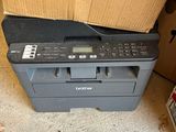 the printer is sitting on top of the box in the room