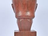 an image of a sculpture of a man ' s head on a wooden base