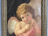 painting of a child with angel wings in a gold frame on a blue wall