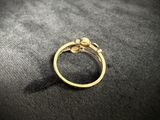 a close up of a gold ring on a black surface