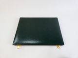 a close up of a black binder on a white surface