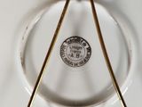 a white plate with a gold handle and a white plate with a gold handle and a white plate with a gold handle and a white plate with a gold