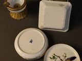 three plates that have birds painted on them on them