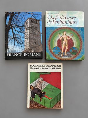 three books on a table with a clock tower in the background