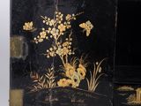 a small black box with a painting of flowers on it
