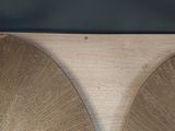 two large wooden discs sitting on a wooden surface