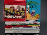 several comics are stacked on top of each other on a table
