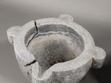 a stone ashtray with a crack in the middle