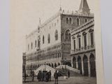 black and white photograph of a group of people standing in front of a building