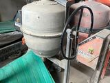 a machine that is sitting in a garage with a green mat