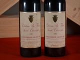 two bottles of red wine sitting on a table