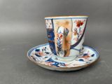 a small cup and saucer on a saucer