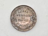 a close up of a coin on a white surface
