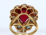 an image of a close up of a ring with a red stone