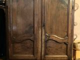 a wooden armoire with a mirror on top of it