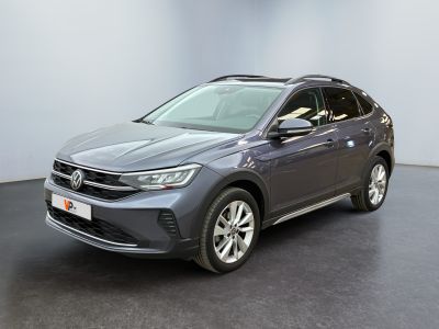 a grey volkswagen suv parked in a room with a black floor
