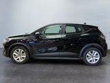 the black car is parked in a room with a gray wall