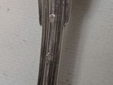 a close up of a silver spoon with a handle on a table