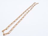 a pair of gold chain bracelets on a white background